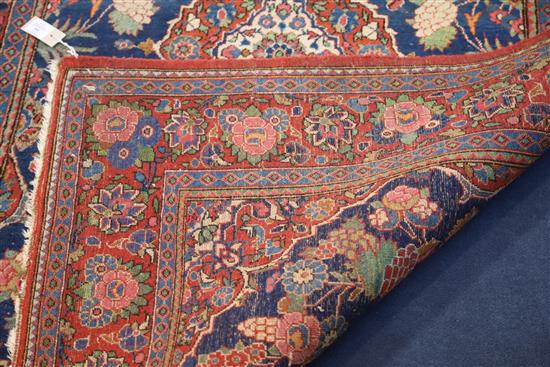 A Kashan blue ground rug, 6ft 8in by 4ft 5in.